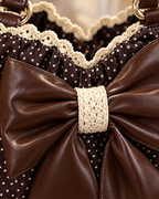 Close-up of the vegan-leather bow and crochet lace